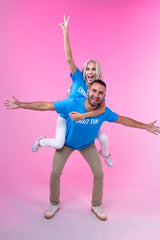 She’s flying, he’s strong—together they’re peak FUN in matching Neon Blue tees. Ride the vibe.