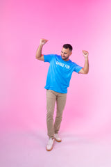 Man flexing in neon blue CHooZ FUN tee against pink background
