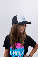 Girl in ChooZ FUN tee wearing Lil’ FUN Mark Hat – White with Blue Patch – side profile
