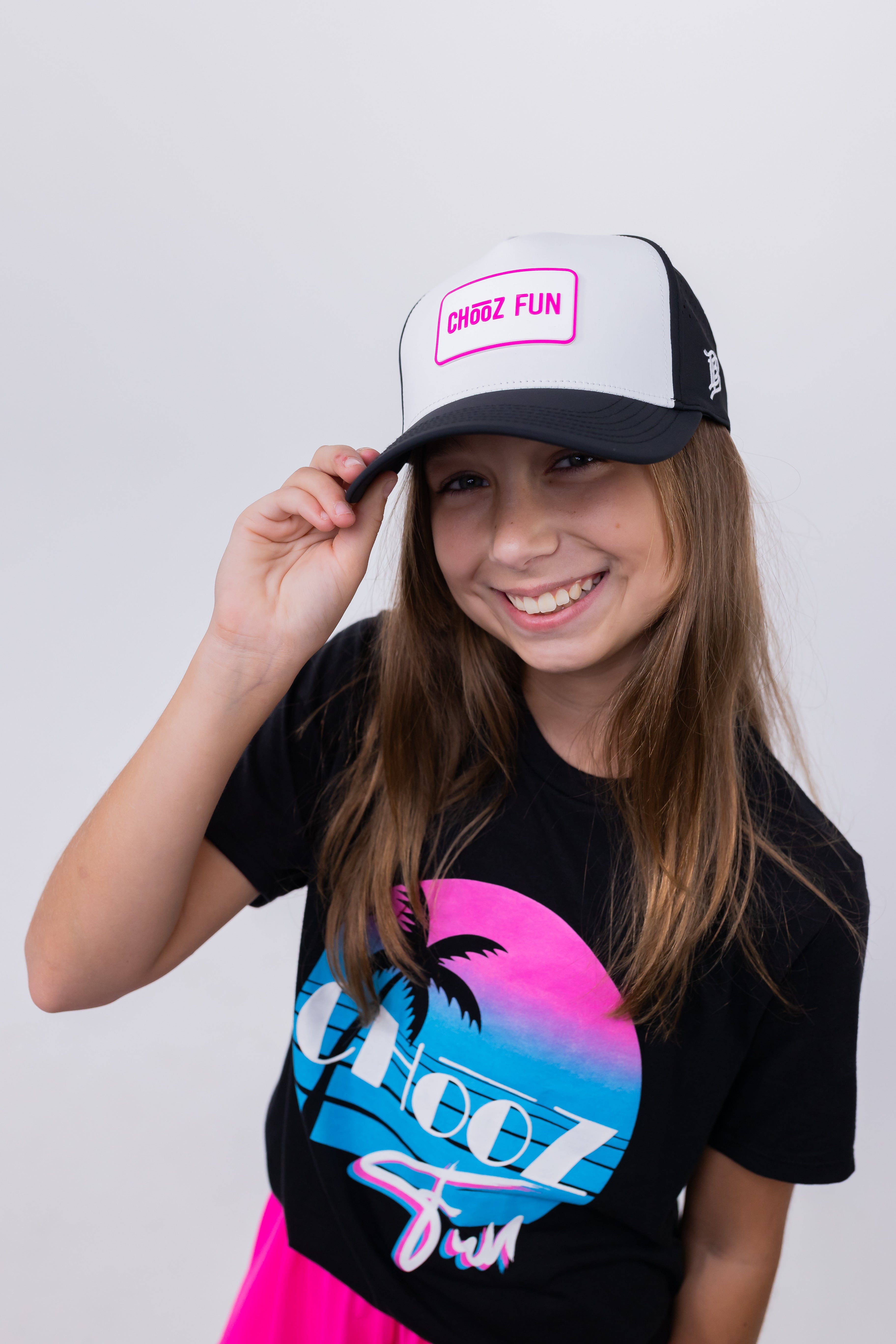 Girl smiling in ChooZ FUN tee wearing Lil’ FUN Mark Hat – White with Pink Patch – front view