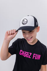 Smiling boy tipping CHooZ FUN Tropic Thunder youth hat – black and white mesh trucker cap with front logo