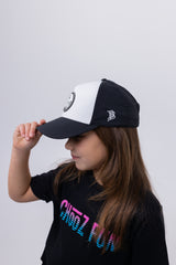 Side profile of girl tipping CHooZ FUN Tropic Thunder youth hat – black and white mesh trucker style